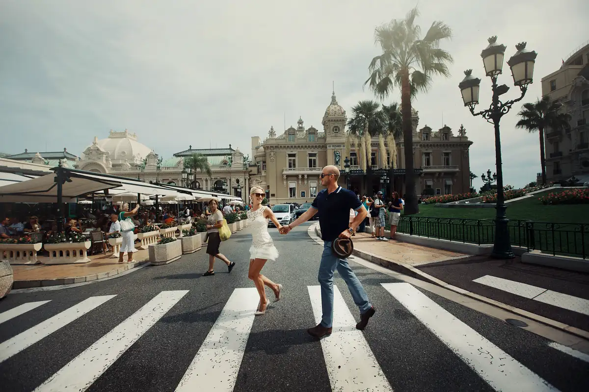 Two pedestrians crossing an urban street at a marked crosswalk